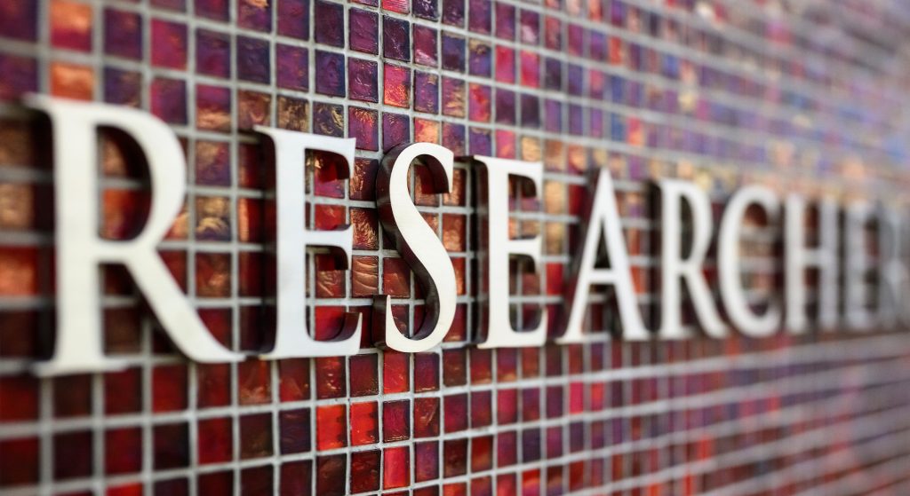 The word research on a red tile mosaic.