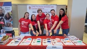 A few Center for Precision Medicine faculty and lab members pose behind their table at UW Science Expeditions 2025.