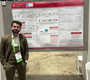 Muhammad Talha Nawaz,MBBS/MD in front of his poster