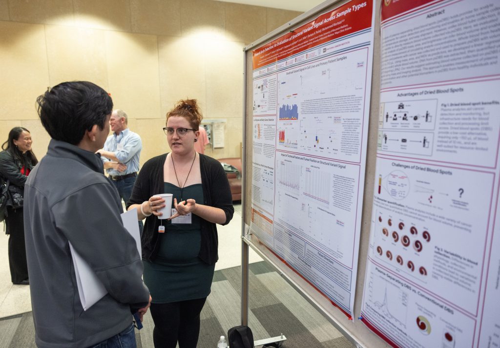 Amanda Schussmn discusses her research poster at the Precision Medicine Symposium 2025