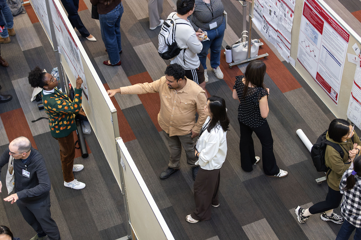 UWSMPH Center for Precision Medicine, Annual Advancing Precision Medicine 2026,. Attendees browse and discuss research posters at a scientific poster session in a conference setting.
