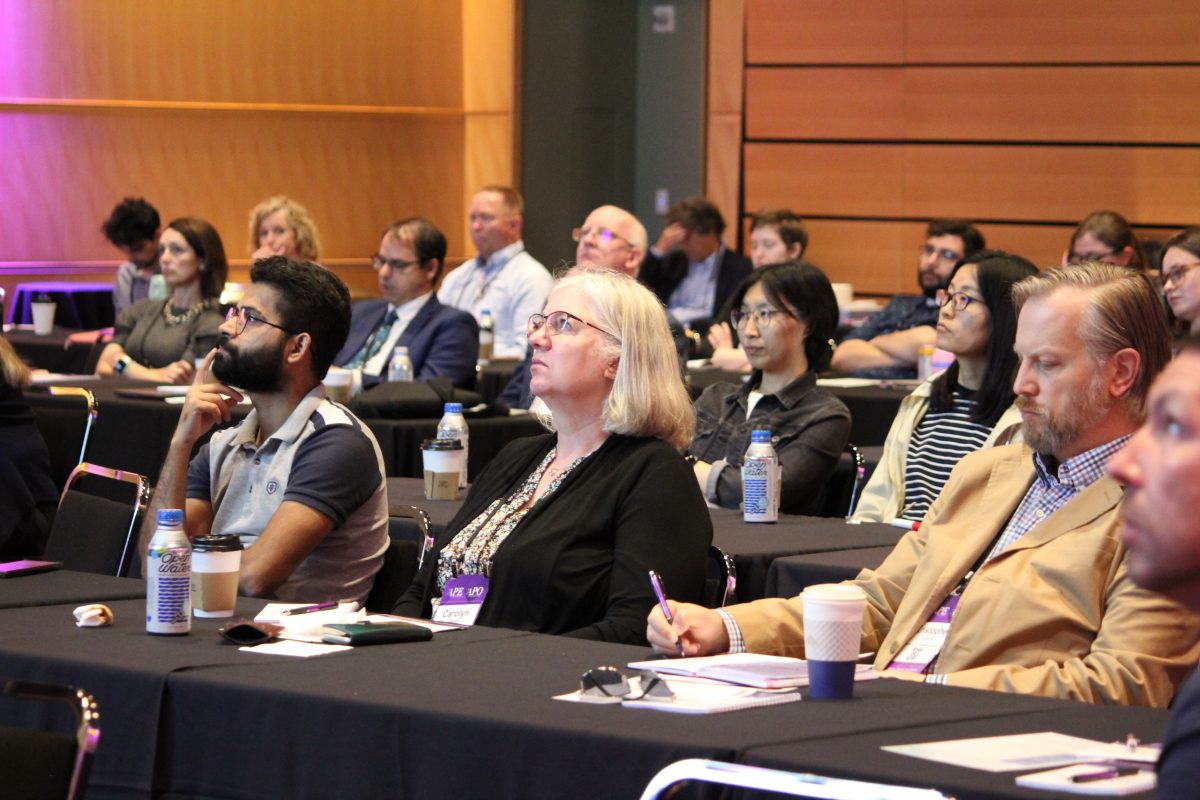 A room full of people attending the Advancing Precision Oncology & Advancing Pathology Education Conference.