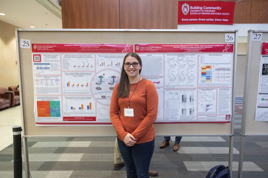 Kristin Adams, Researcher in the Lang Lab, standing before her scientific poster at the Precision Medicine Symposium 2025