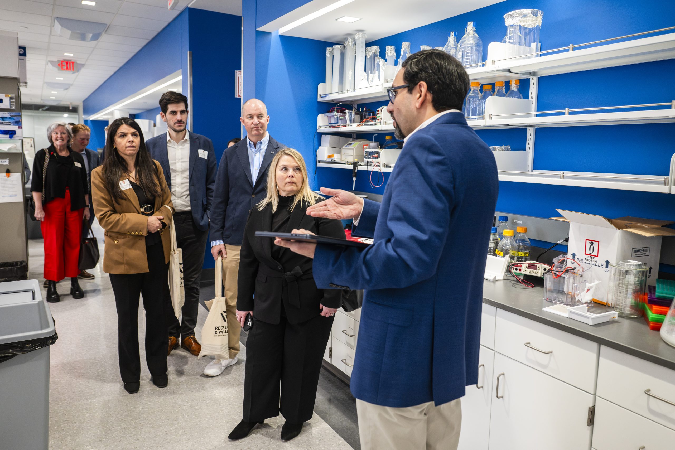 Muhammed Murtaza, Director for Center for Precision Medicine and associate professor in the Department of Surgery leads Abbott representatives including Joana Araújo, Senior Director of Transfusion Medicine, Brad Silber, Director of Public Affairs, Melissa Brotz, Chief Marketing, Communications, and Sustainability Officer, and Chris Miller, Division Vice President of Partnerships and Sponsorship during a tour of the Center for Precision Medicine lab. 
